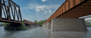 A digital rendering of the proposed Long Bridge Project depicts a new two-track rail bridge spanning the Potomac River between Arlington, Virginia, and Washington, D.C. The design features a modern steel structure supported by concrete piers, running parallel to the existing Long Bridge. This addition aims to enhance rail capacity and improve connectivity in the region.