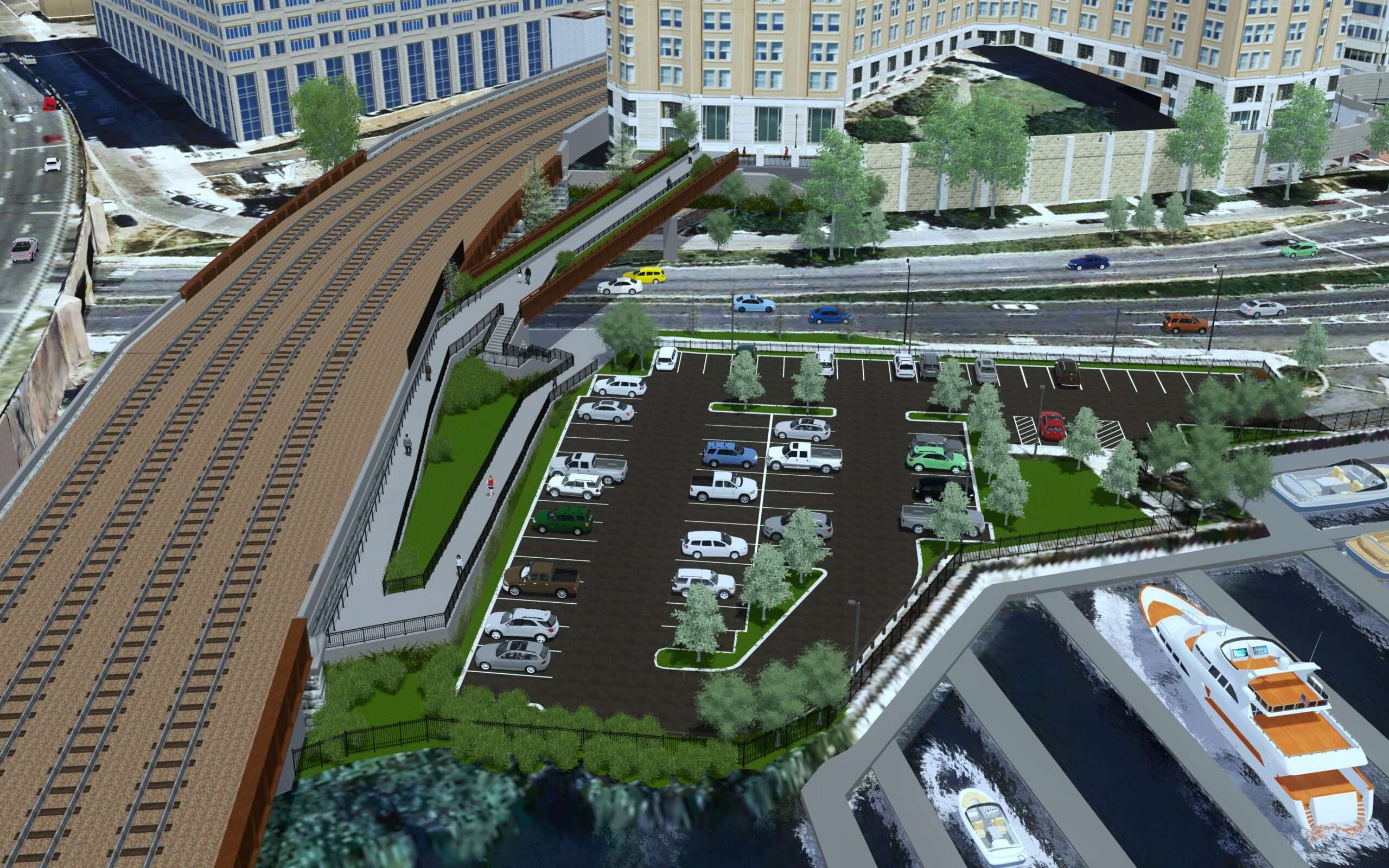 Aerial view of a parking lot adjacent to a railway, featuring parked cars, greenery, a pathway for pedestrians, and a marina with boats nearby.