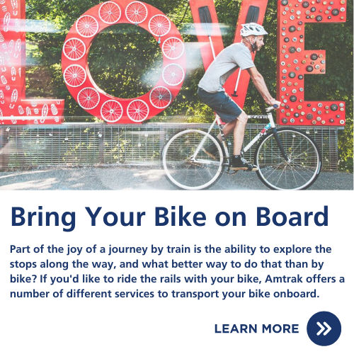 Cyclist in front of Virginia LOVE sign and information about bringing a bike on amtrak trains.